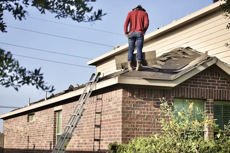 Professional roofer working on a residential roof in Richville